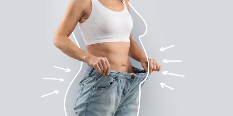 Woman wearing a loose pant to show her aftermath of weight loss.