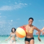 Adult friends playing in the sea on holiday