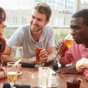 Friends drinking outdoors on a rooftop bar