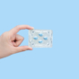hand holding packet of blue pills