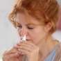 Woman using nasal spray