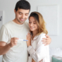 happy couple looking at pregnancy test