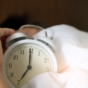 adult alarm clock in bed