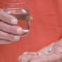man holding viagra and glass of water