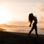 woman enjoying beach at sunset