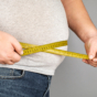 man measuring his waist