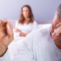 man holding pill in front of partner