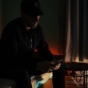 man scrolling phone in dark