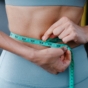 woman measuring waistline