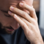 man with head in hands