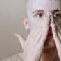 man washing his face