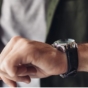 man looking at wrist watch