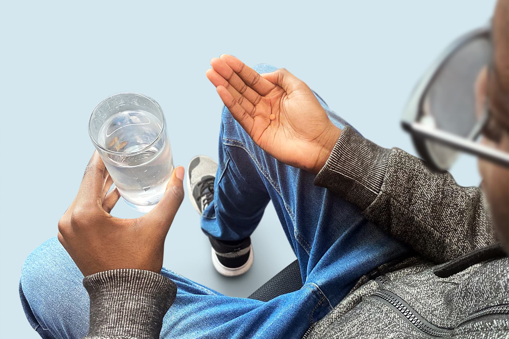 A man about to swallow a finasteride pill with water