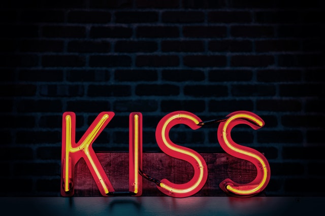 A red kiss sign on black background