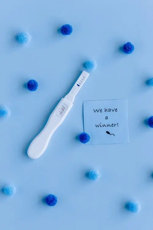 Image of a positive pregnancy test against a blue background