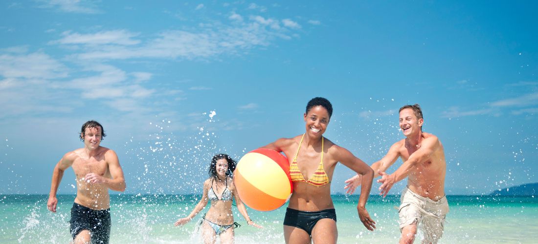 Friends playing in the sea on holiday