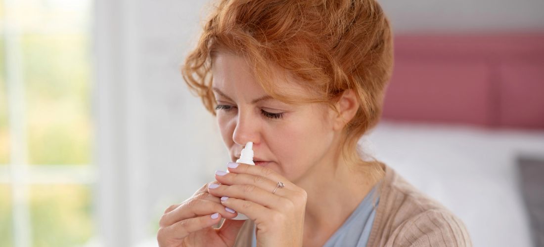Woman using nasal spray