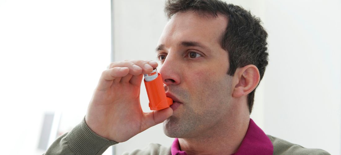 Man taking inhaler