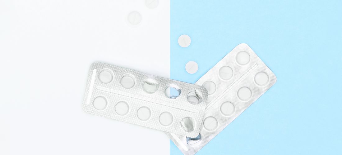 Pills on blue and white background