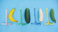 A collection of vegetables next to measuring equipment on a blue background