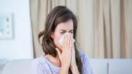 Woman blowing nose