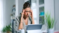 Woman experiencing dizziness at her desk