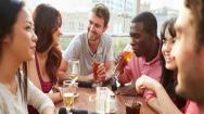 Friends drinking outdoors on a rooftop bar