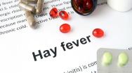 The word hay fever surrounded by pills