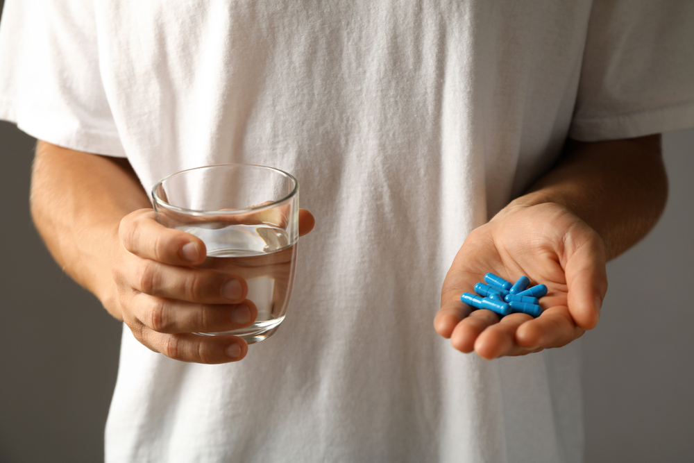 man-holding-blue-viagra-pills.jpg